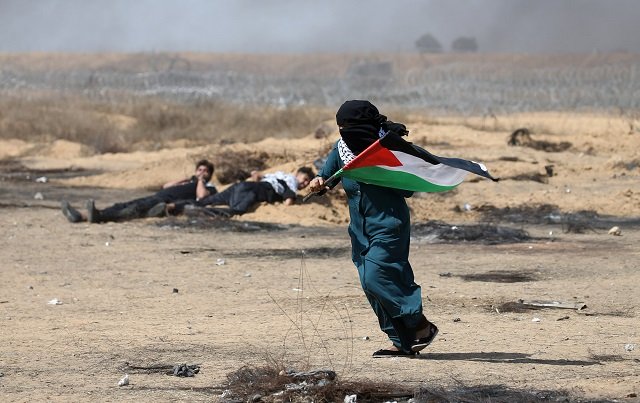 a female demonstrator holding a palestinian flag runs during a protest marking al quds day jerusalem day at the israel gaza border in the southern gaza strip june 8 2018 photo reuters