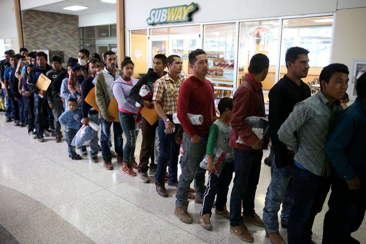 file photo undocumented immigrants just released from detention through catch and release immigration policy stand at a bus station before being taken to the catholic charities relief center in mcallen texas u s april 11 2018 reuters loren elliott file photo