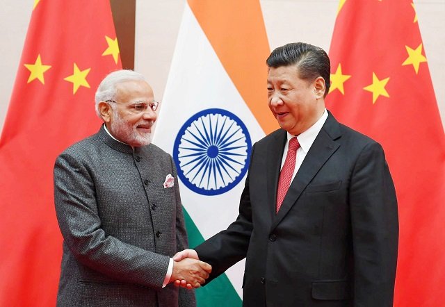 india 039 s prime minister narendra modi shakes hands with chinese president xi jinping during the 18th shanghai cooperation organisation sco summit in qingdao china june 9 2018 photo afp
