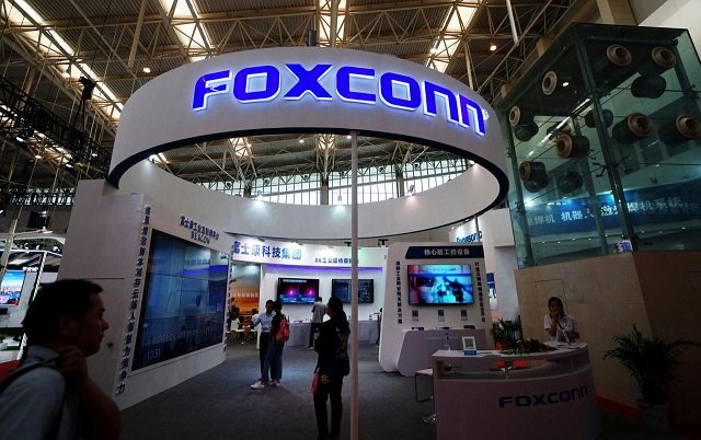 visitors are seen at a foxconn booth at the world intelligence congress in tianjin china may 19 2018 photo reuters