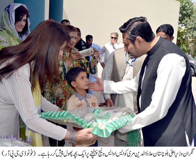 an orphan child presents a bouquet to caretaker chief minister alauddin marri upon his visit to sos children 039 s village in quetta photo express