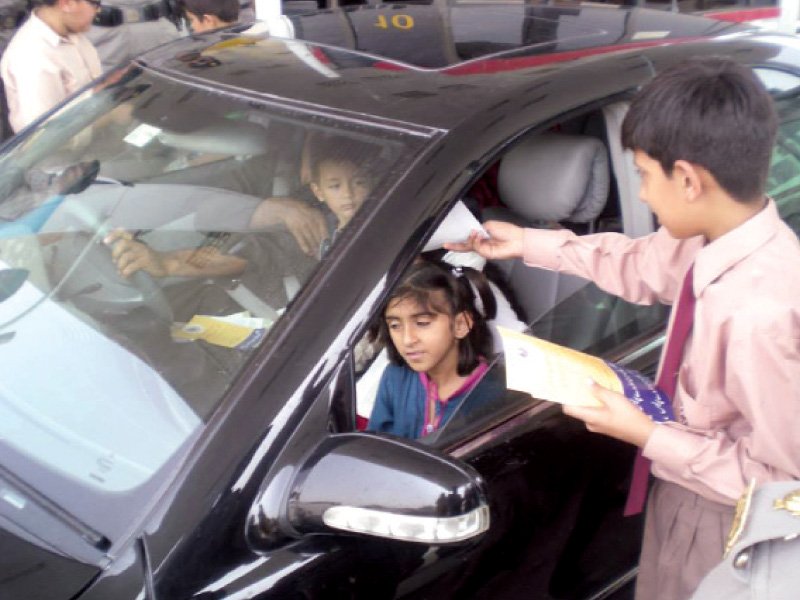 photo of a child distributing road safety flyers photo press release
