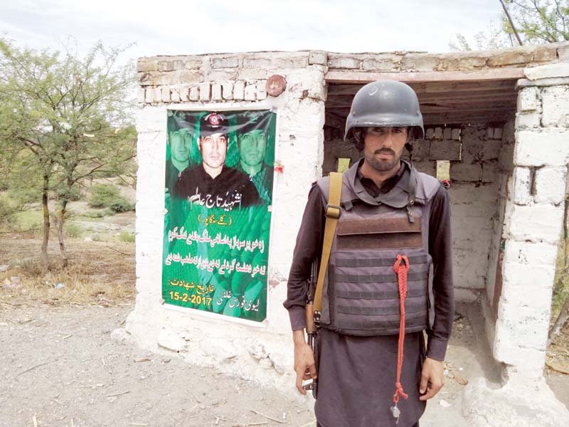 a paramilitary man stands at a defunct picket in mohmand for local tax collection photo express