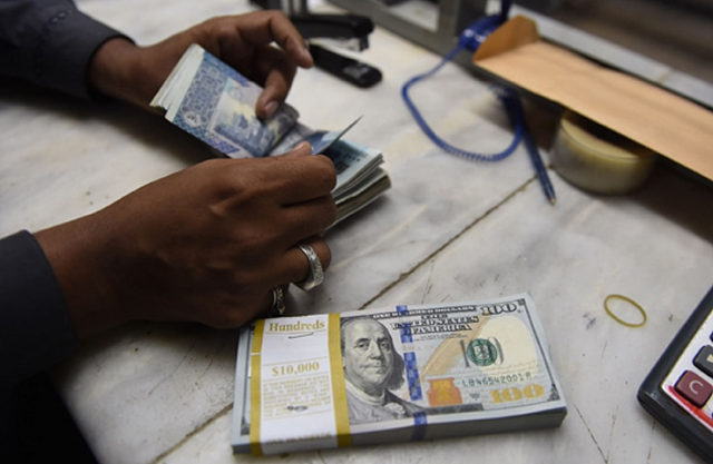 some currency dealers temporarily suspended dollar buying and selling during the day after the rupee slumped in the inter bank market photo afp