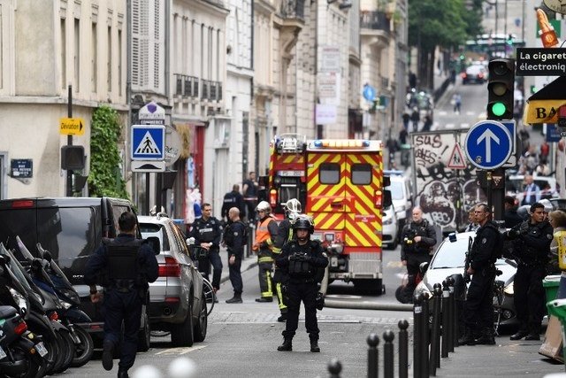 police officers stand on a street near the site of an ongoing hostage taking on june 12 2018 in central paris photo afp