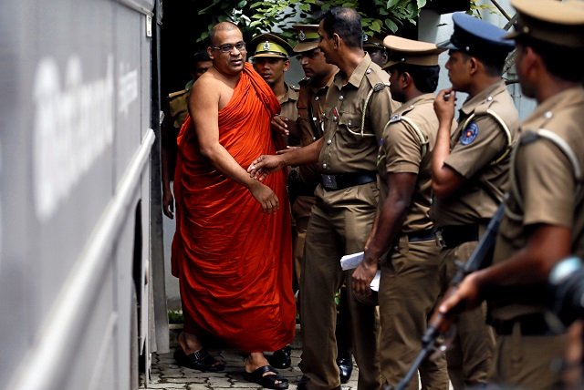 galaboda aththe gnanasara thero head of buddhist group bodu bala sena bbs walks towards a prison bus while accompanied by prison officers after he was sentenced by a court photo reuters