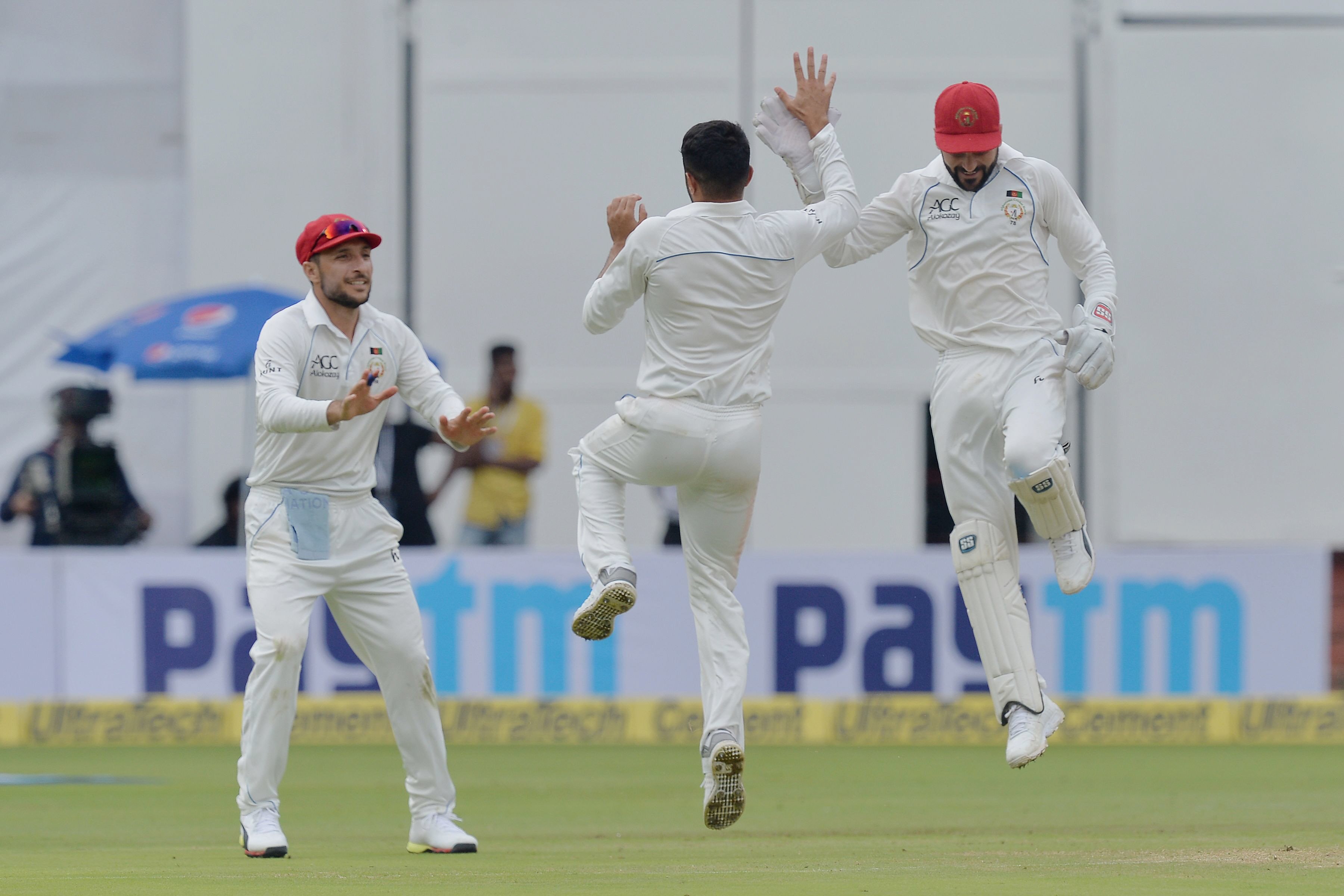 afghanistan bowler yamin ahmadzai c celebrates with wicketkeeper afsar khan zazai r the dismissal of indian batsman kl rahul photo afp