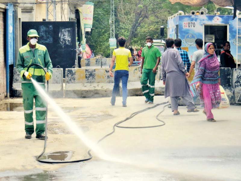 a worker of the albayrak waste management company washes a road photo online