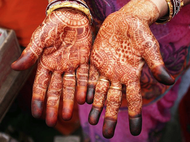 Beautiful woman dressed up as Indian tradition with henna mehndi design on  her both hands to celebrate big festival of Karwa Chauth, Karwa Chauth  celebrations by Indian woman for her husband 16106026