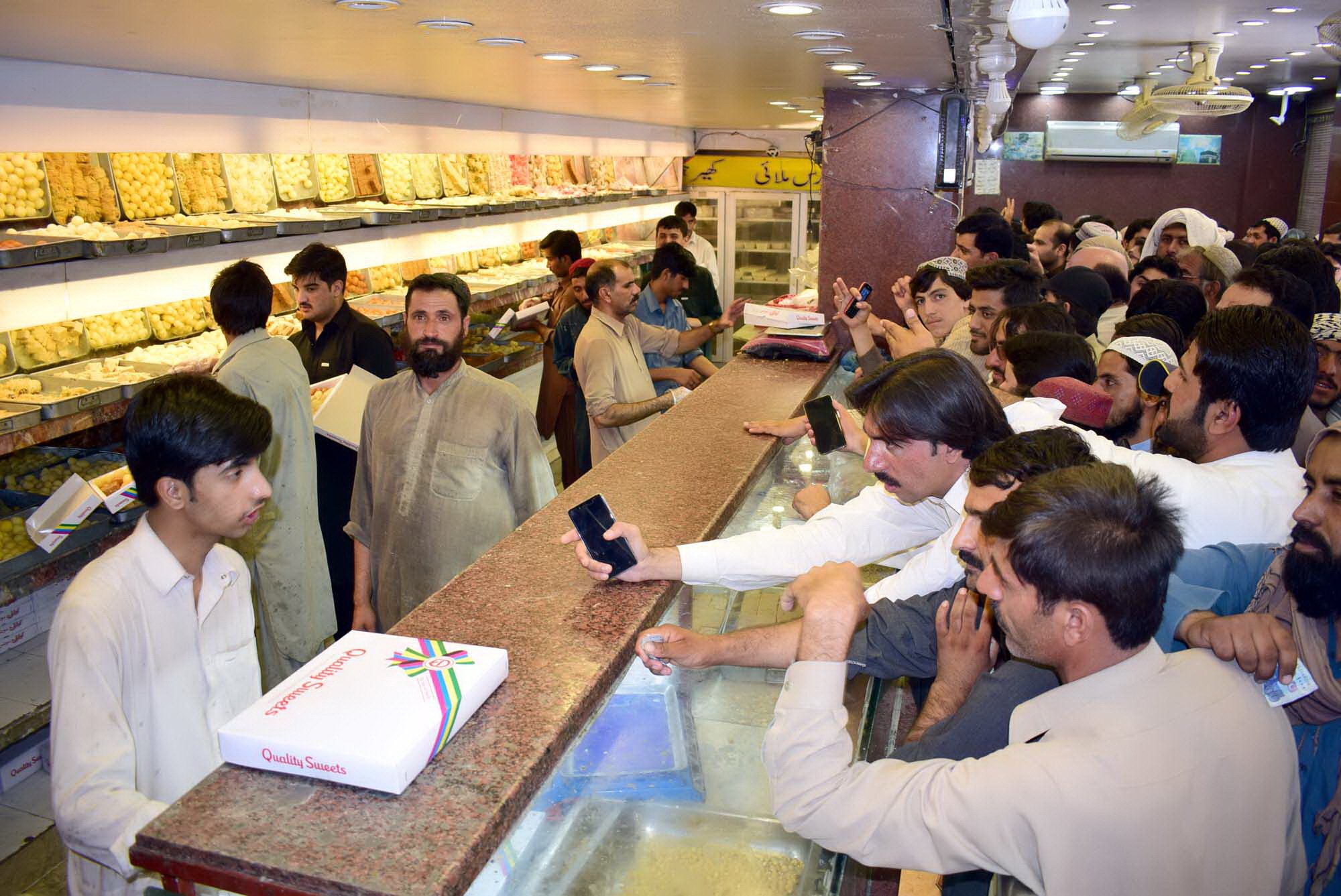 a rush of people can be seen at a bakery and sweets shop in quetta on chand raat photo express