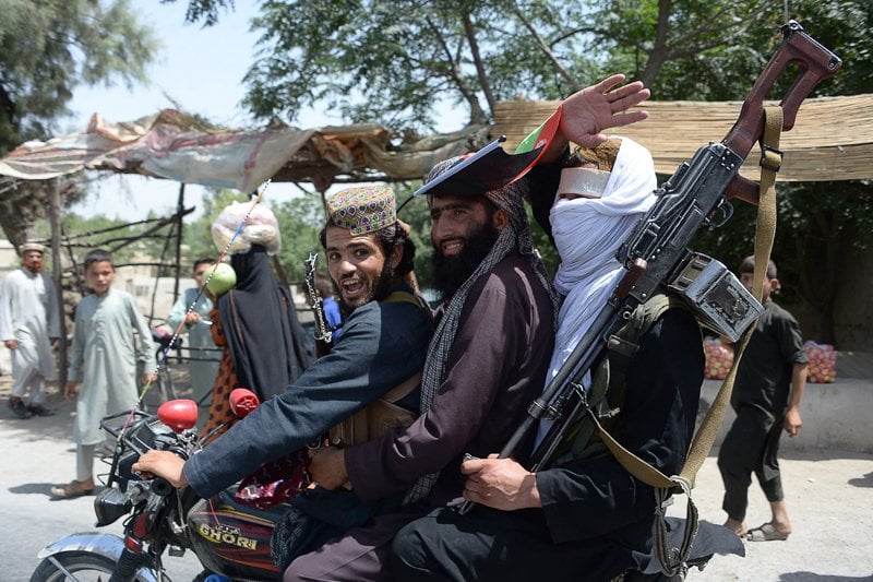 afghan taliban ride a motorbike as they took to the street to celebrate ceasefire on the second day of eid on the outskirts of jalalabad on june 16 2018 photo afp