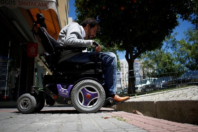 wheelchair user ricardo teixeira demonstrates being unable to proceed to the sidewalk in lisbon portugal june 15 2018 photo reuters