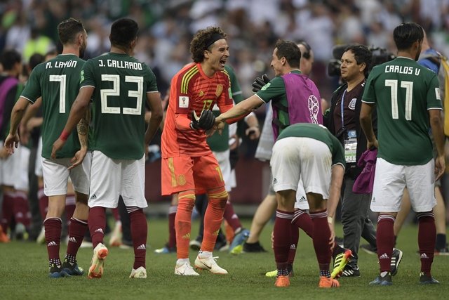 keeping them out mexico goalkeeper guillermo ochoa c l celebrates with skipper andres guardado 3r after their win over germany photo afp