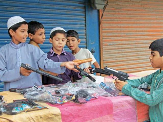 children playing with toy guns despite a ban imposed by the government photo express