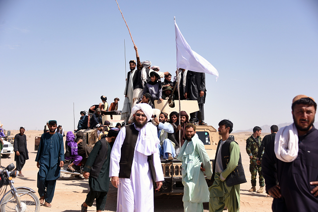 afghan taliban militants and residents stand on a armoured humvee vehicle of the afghan national army ana as they celebrate a ceasefire on the third day of eid in maiwand district of kandahar province photo afp afghan taliban militants and residents stand on a armoured humvee vehicle of the afghan national army ana as they celebrate a ceasefire on the third day of eid in maiwand district of kandahar province photo afp