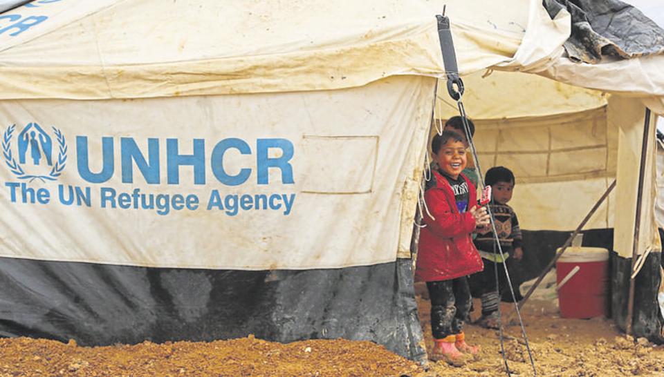 iraqi refugees mostly fleeing the northern city of mosul stand at a new camp on the outskirts of the syrian town of ras al ain on the border with turkey photo afp