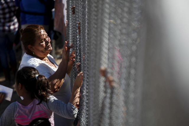 a woman touches a family member through the border fence between ciudad juarez and el paso united states after a bi national mass in support of migrants in ciudad juarez mexico photo reuters a woman touches a family member through the border fence between ciudad juarez and el paso united states after a bi national mass in support of migrants in ciudad juarez mexico photo reuters