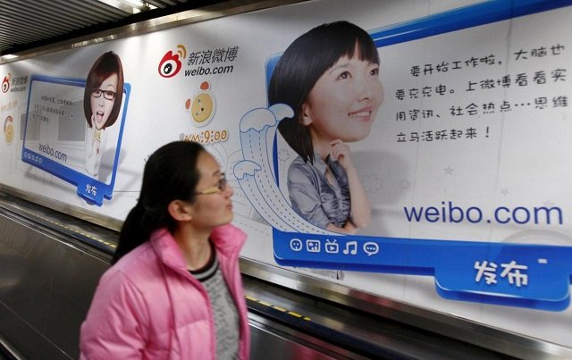 a woman looks at a weibo advertisement as she rides an elevator inside a subway station in beijing february 25 2012 china 039 s weibo corp will be valued at a lower than expected 3 46 billion when it goes public on the nasdaq on april 17 2014 amidst concerns about the microblogging service 039 s slowing user growth picture taken february 25 2012 photo reuters