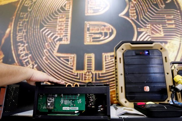 a cryptocurrency mining computer is seen in front of bitcoin logo during the annual computex computer exhibition in taipei taiwan june 5 2018 photo reuters