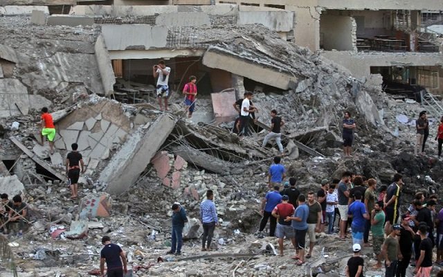 iraqis inspect the aftermath of an explosion in an arms depot in baghdad 039 s sadr city district on june 7 2018 that killed at least 16 people photo afp