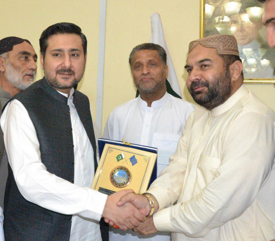 caretaker chief minister alauddin marri being presented a shield by qcci senior vice president ayub khilji photo express caretaker chief minister alauddin marri being presented a shield by qcci senior vice president ayub khilji photo express