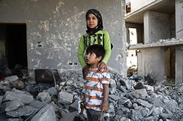 syrian girl inas haymur and her brother saad down pose for a photograph in afrin on may 26 2018 photo afp syrian girl inas haymur and her brother saad down pose for a photograph in afrin on may 26 2018 photo afp