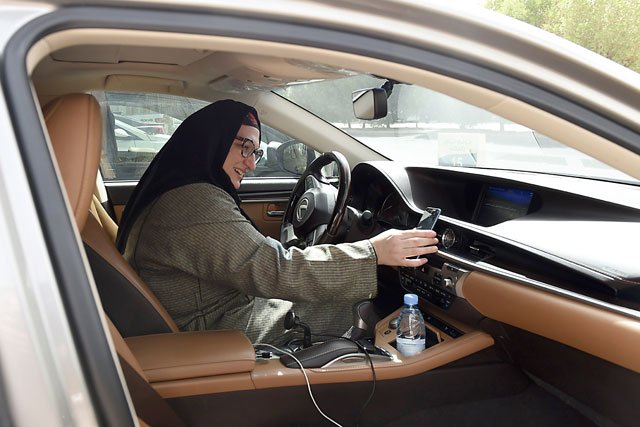 saudi national and newly licensed reem farahat an employee of careem a chauffeur car booking service prepares for a customer shuttle using her car in the saudi capital of riyadh photo afp