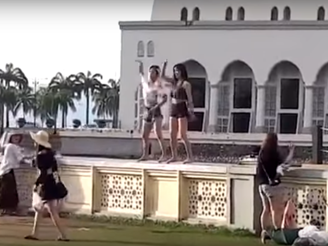 pair of women were filmed doing the dance in skimpy shorts and tops outside the mosque youtube screengrab pair of women were filmed doing the dance in skimpy shorts and tops outside the mosque youtube screengrab