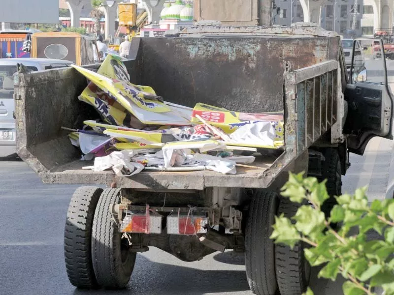 a garbage truck takes away posters of political leaders photo agha mehroz express a garbage truck takes away posters of political leaders photo agha mehroz express