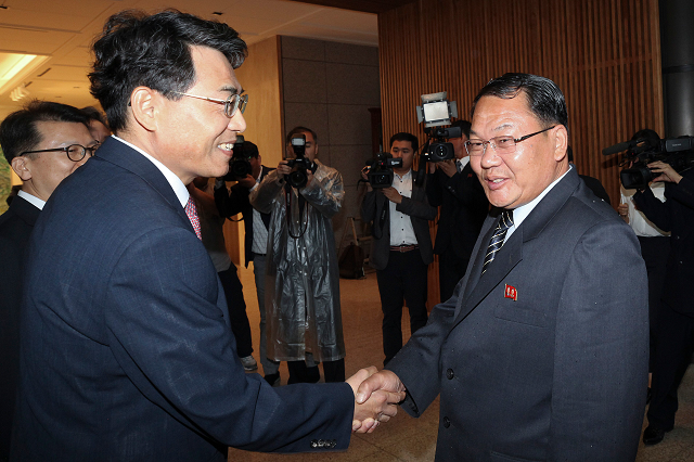 south korea 039 s chief delegate vice transport minister kim jeong ryeol shaking hands with his north korean counterpart vice railroad minister kim yun hyok during their meeting at the south side of the truce village of panmunjom in the demilitarized zone dmz dividing the two koreas photo afp