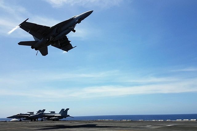an f18 fighter takes off from the deck of the uss theodore roosevelt while transiting the south china sea april 10 2018 photo reuters