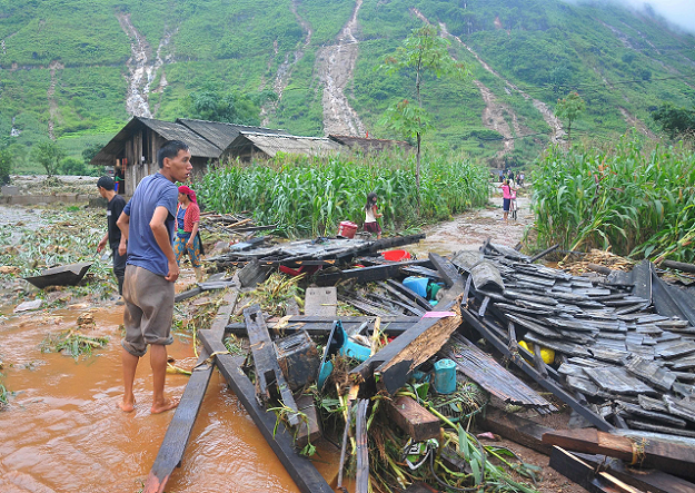 A Vietnamese man looking at the debris of his house destroyed by flash floods in northern Ha Giang province. PHOTO: AFP