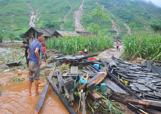 a vietnamese man looking at the debris of his house destroyed by flash floods in northern ha giang province photo afp