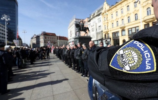 a police officer stands by as supporters of a croatian far right party gather in ban jelacic square in downtown zagreb photo afp