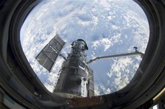 this still photo image shows the hubble space telescope after its 039 grapple by the space shuttle atlantis 039 s robot arm photo reuters