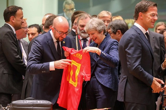 belgium 039 s prime minister charles michel c l offers a jersey of belgian football national team 039 s forward eden hazard to britain 039 s prime minister theresa may during an european union leaders 039 summit focused on migration brexit and eurozone reforms on june 28 2018 photo afp