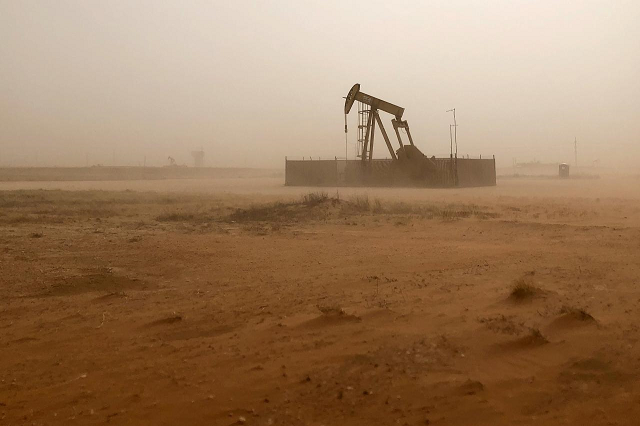 a pump jack lifts oil out of a well during a sandstorm in midland texas us photo reuters
