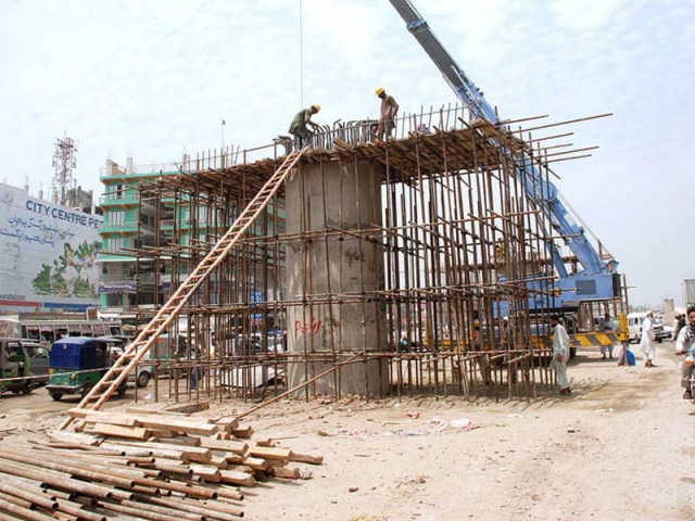 labourers constructing a pillar of the bus rapid transit project at firdous chowk in peshawar photo app labourers constructing a pillar of the bus rapid transit project at firdous chowk in peshawar photo app