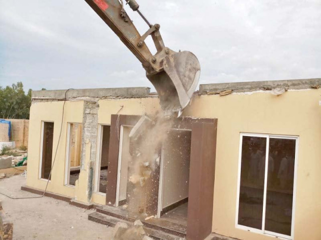 cda staff use an excavator to tear down a structure on the illegally occupied land in sector f 11 3 photo express