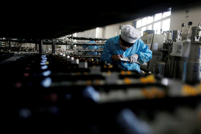 a labourer works inside an electronics factory in qingdao shandong province china photo reuters