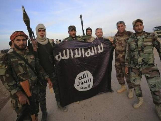fighters pose with an islamic state flag photo reuters fighters pose with an islamic state flag photo reuters