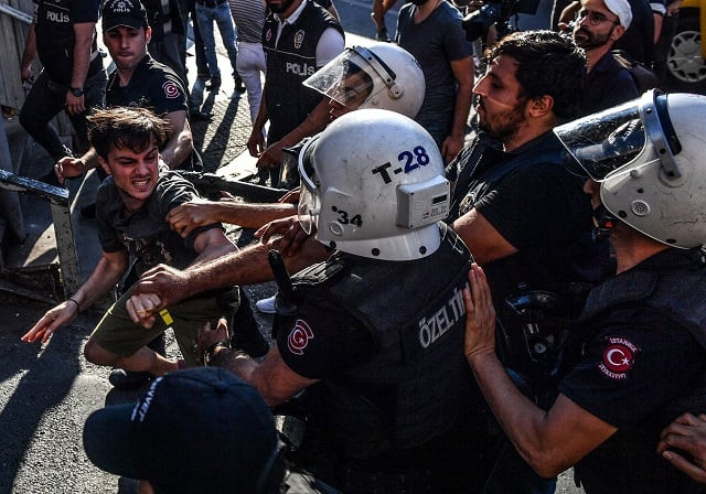 turkish riot policemen beats a lgbt rights activist after turkish authorities banned the event for a fourth year in a row on july 1 2018 in istanbul photo afp turkish riot policemen beats a lgbt rights activist after turkish authorities banned the event for a fourth year in a row on july 1 2018 in istanbul photo afp