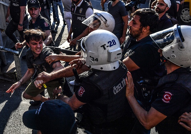 turkish riot policemen beats a lgbt rights activist after turkish authorities banned the event for a fourth year in a row on july 1 2018 in istanbul photo afp