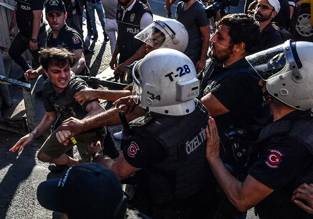 turkish riot policemen beats a lgbt rights activist after turkish authorities banned the event for a fourth year in a row on july 1 2018 in istanbul photo afp turkish riot policemen beats a lgbt rights activist after turkish authorities banned the event for a fourth year in a row on july 1 2018 in istanbul photo afp