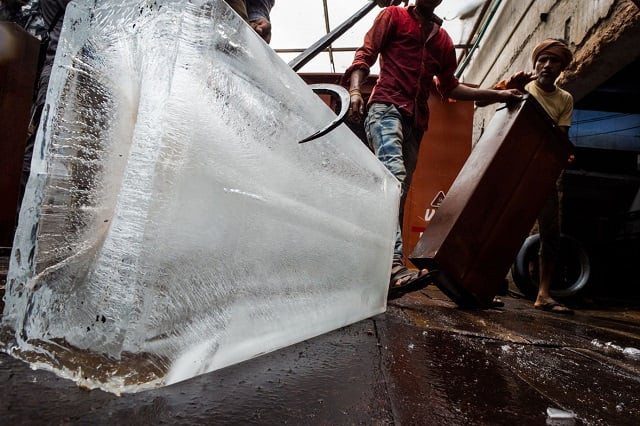 indian labourers load ice blocks into a transportation van in an ice factory in noida some 20km east of new delhi photo afp indian labourers load ice blocks into a transportation van in an ice factory in noida some 20km east of new delhi photo afp