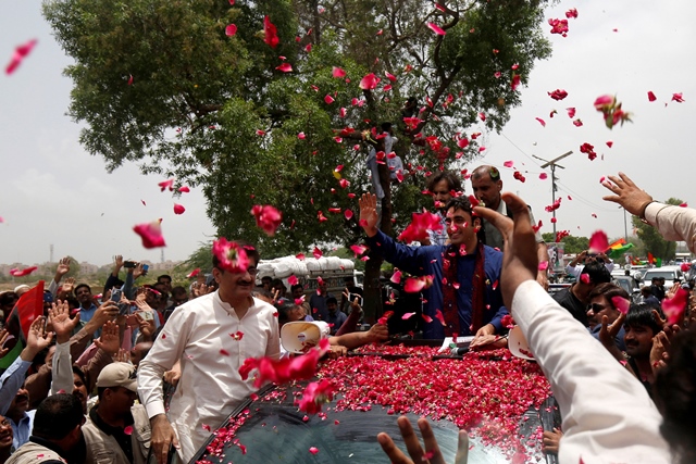 bilawal bhutto zardari receives a rose petal welcome from supporters as he heads for a campaign rally ahead of general elections on the outskirts of karachi photo reuters