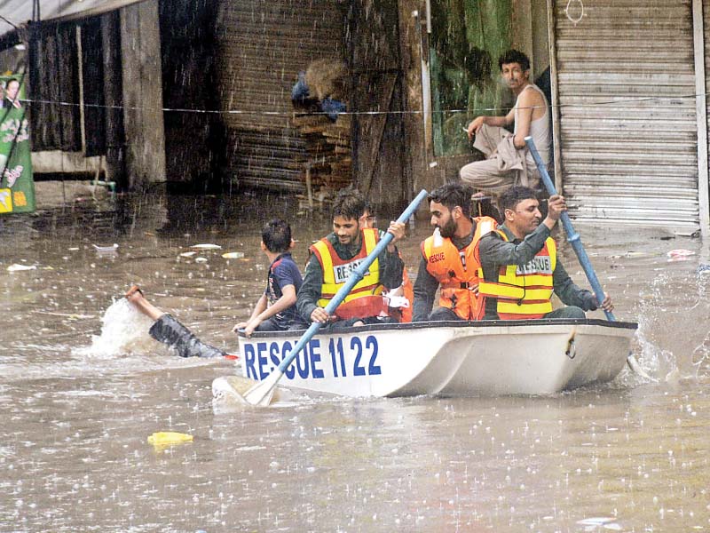 rescue worker use a boat for rescue operation on a flooded road after the intense rainfall in lahore at least six people were killed in rain related incidents photo online