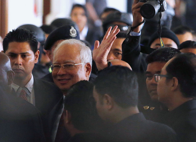 najib who spent the night in detention arrived at the court complex in the capital kuala lumpur wearing a dark blue suit and a red tie photo reuters