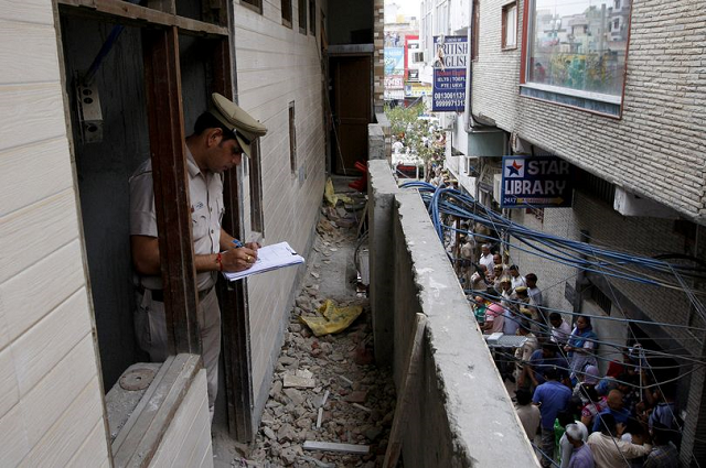 a policeman write notes in the family 039 s new delhi home during an investigation photo reuters a policeman write notes in the family 039 s new delhi home during an investigation photo reuters