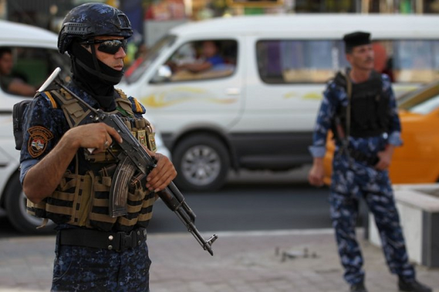 members of the iraqi federal police patroling the streets of baghdad 039 s shula district photo afp